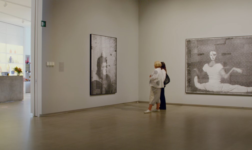 Two people admiring artwork in gallery