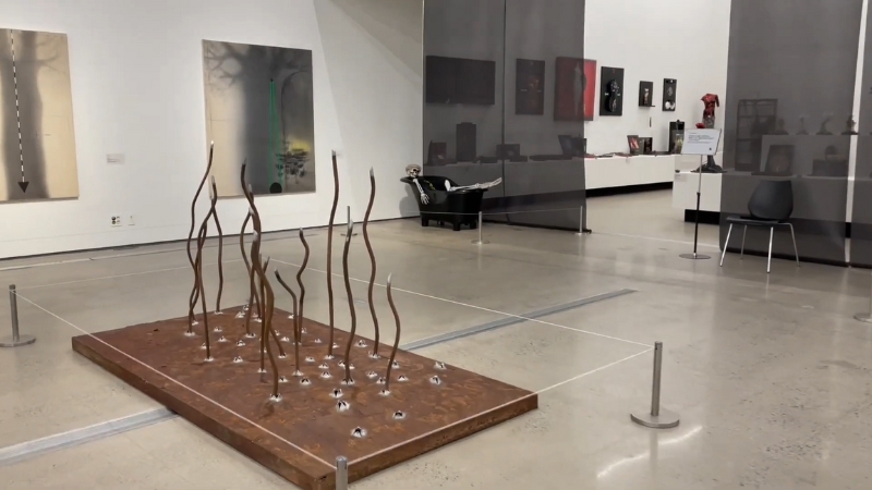 A contemporary art installation with tall, curved metal rods is displayed inside the National Museum of Modern and Contemporary Art in South Korea